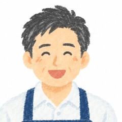 前かけ姿のお店の男性の、笑顔